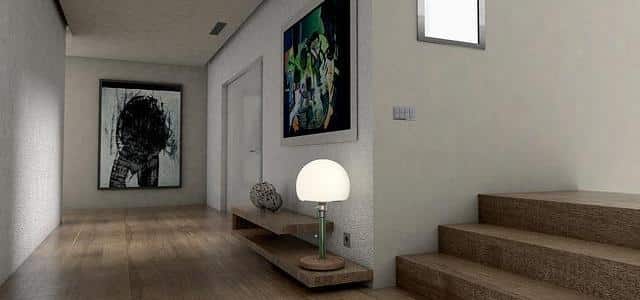 A Hallway With A Lamp And A Painting On The Wall